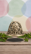 Metal wind chime with intricate floral motif